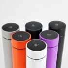 Golf bottle with LED display next to golf bag on course