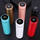 Stainless golf bottle with custom color and LED lid placed on grass